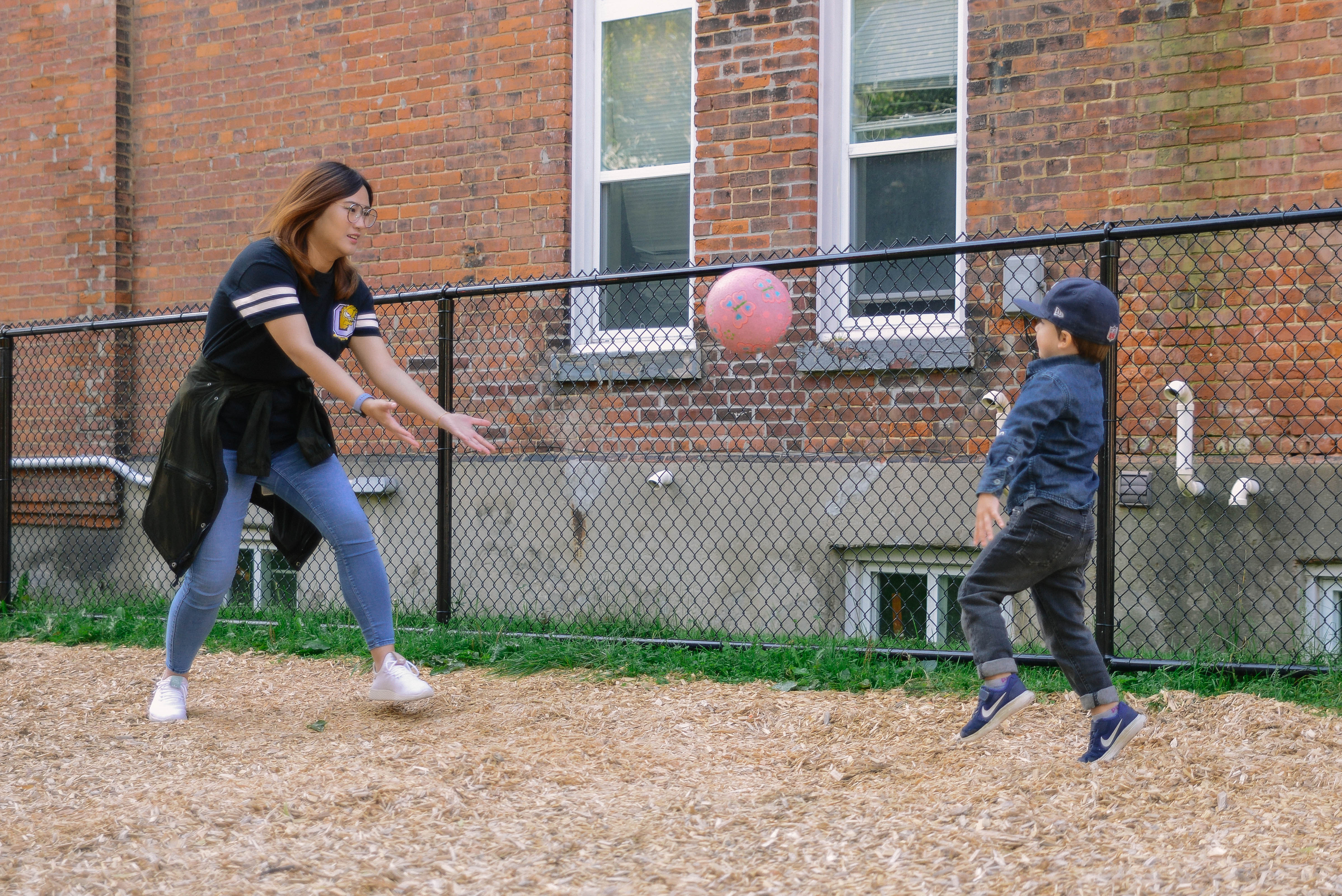Adult and a child playing ball together